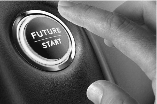 Close-up of a hand pressing a button labeled "Future Start" on a sleek surface.